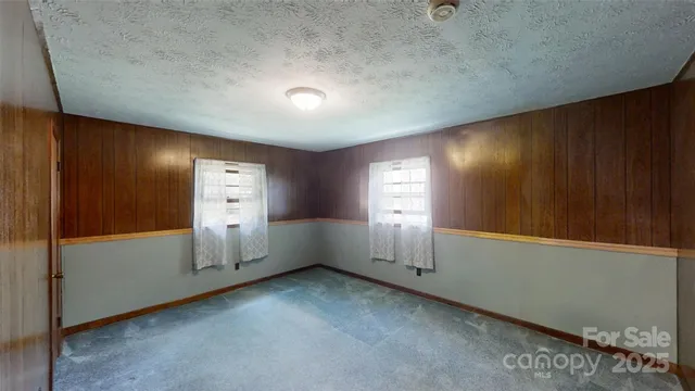 a view of an empty room with wooden walls