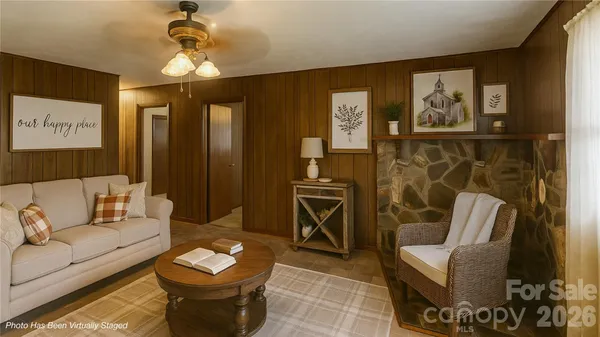 a living room with furniture a lamp and a chandelier
