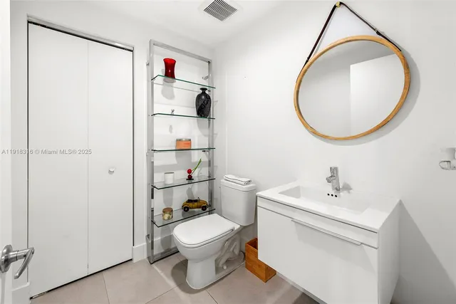 a bathroom with a toilet and a mirror