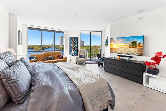 a bed room with a bed and a flat screen tv