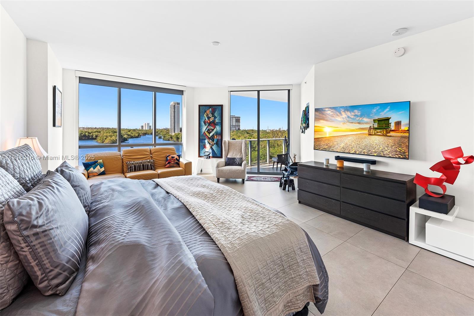 17111 Biscayne Boulevard, Unit 606 North Miami Beach, FL 33160 - Photo 18 of 36 a bed room with a bed and a flat screen tv