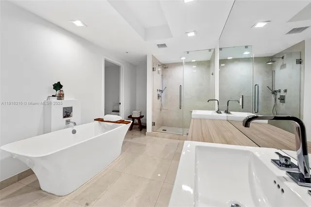 a large white bathroom with a large tub sink and vanity