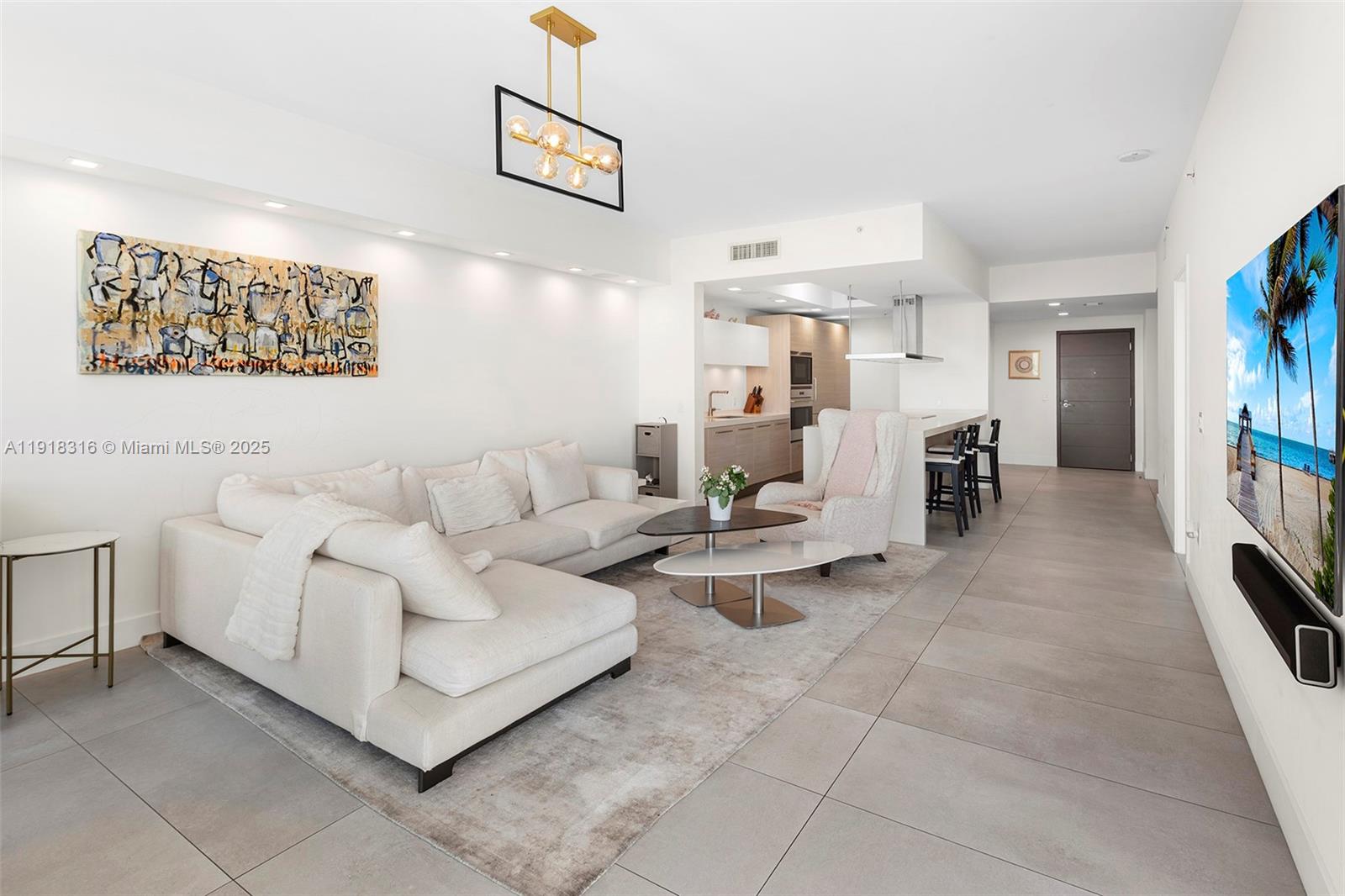 17111 Biscayne Boulevard, Unit 606 North Miami Beach, FL 33160 - Photo 3 of 36 a living room with furniture and a table