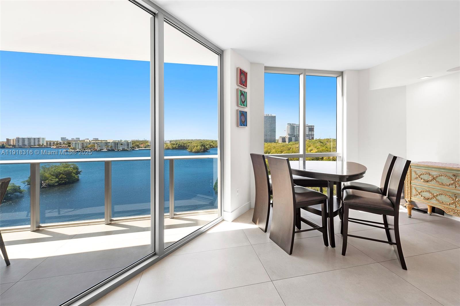 17111 Biscayne Boulevard, Unit 606 North Miami Beach, FL 33160 - Photo 4 of 36 a dining room with furniture and a floor to ceiling window