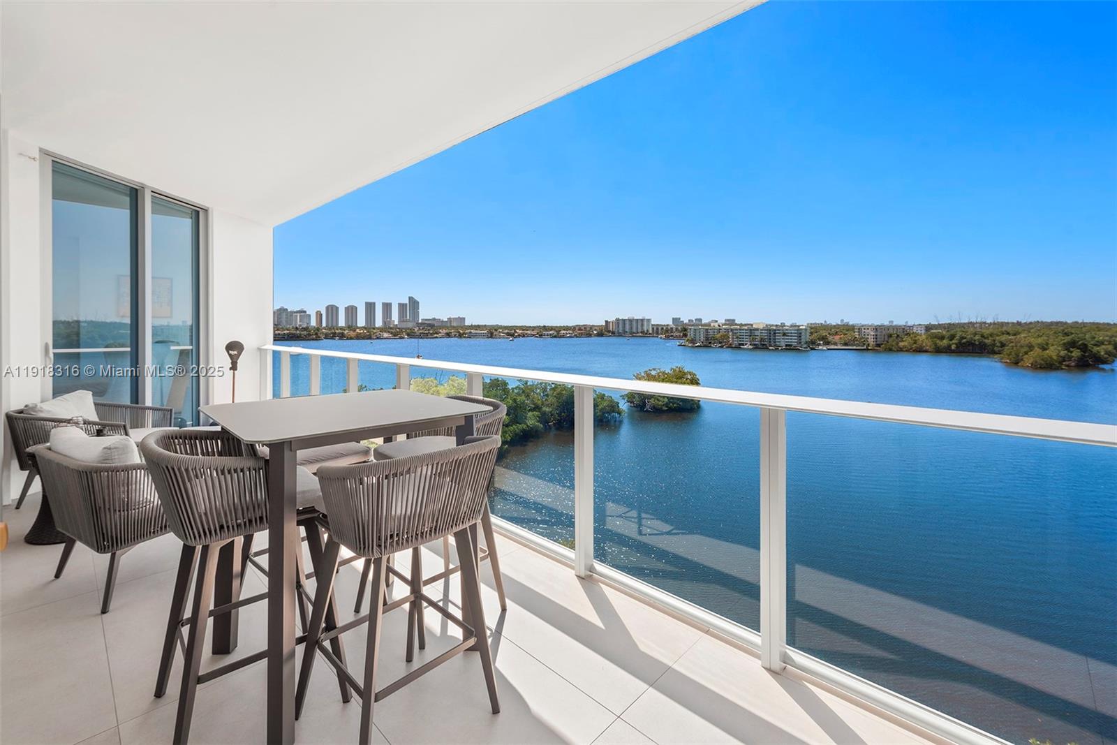 17111 Biscayne Boulevard, Unit 606 North Miami Beach, FL 33160 - Photo 6 of 36 a view of a chairs and table on the terrace