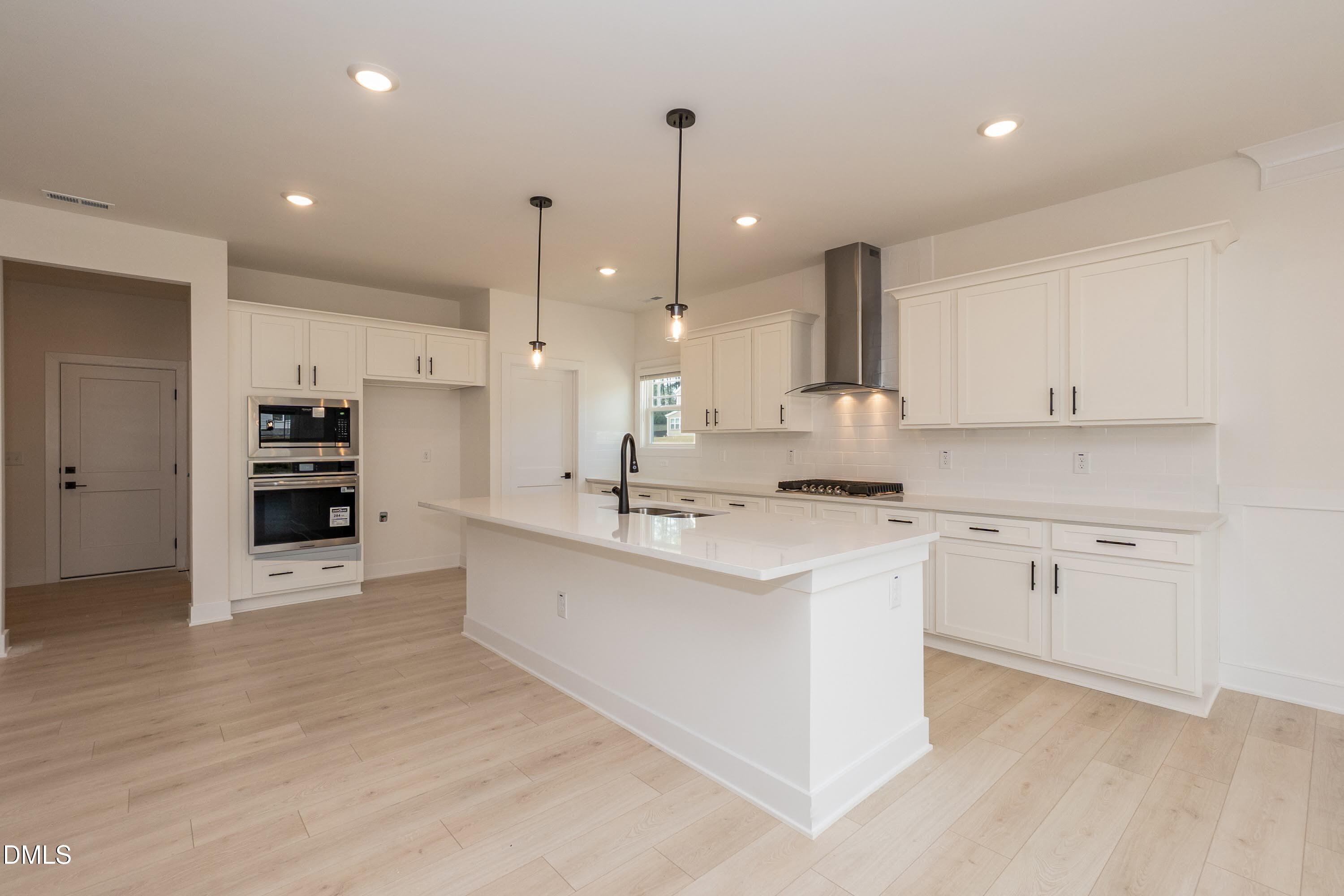 180 Galway Road Lillington, NC 27546 - Photo 11 of 41 a kitchen with stainless steel appliances kitchen island granite countertop a sink and cabinets