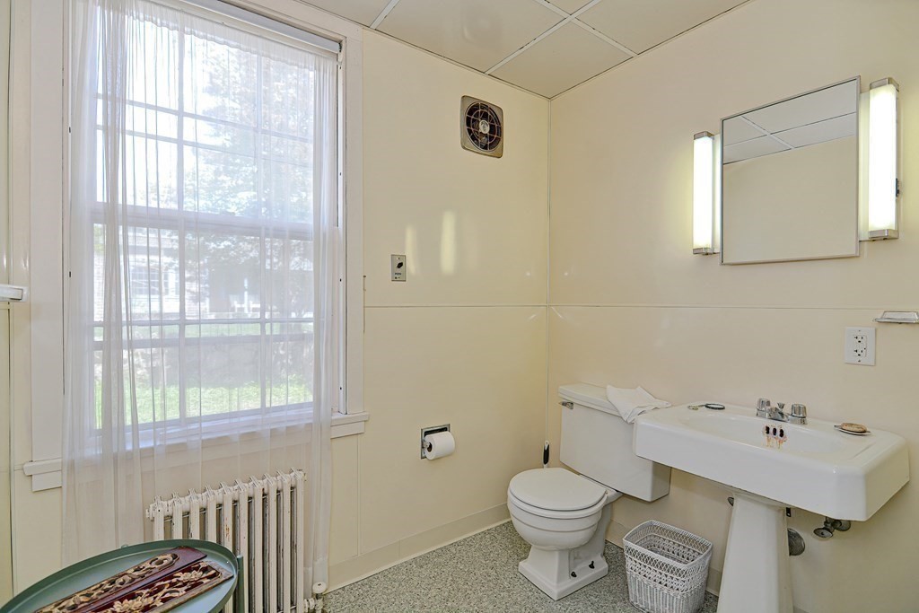 1904 Main Road Westport, MA 02791 - Photo 16 of 42 a bathroom with a sink a toilet and a window