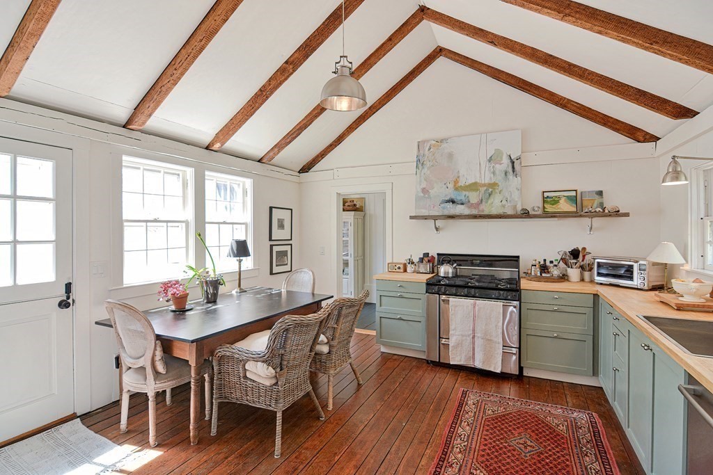 1904 Main Road Westport, MA 02791 - Photo 20 of 42 a kitchen with stainless steel appliances granite countertop a stove a sink dishwasher and cabinets with wooden floor