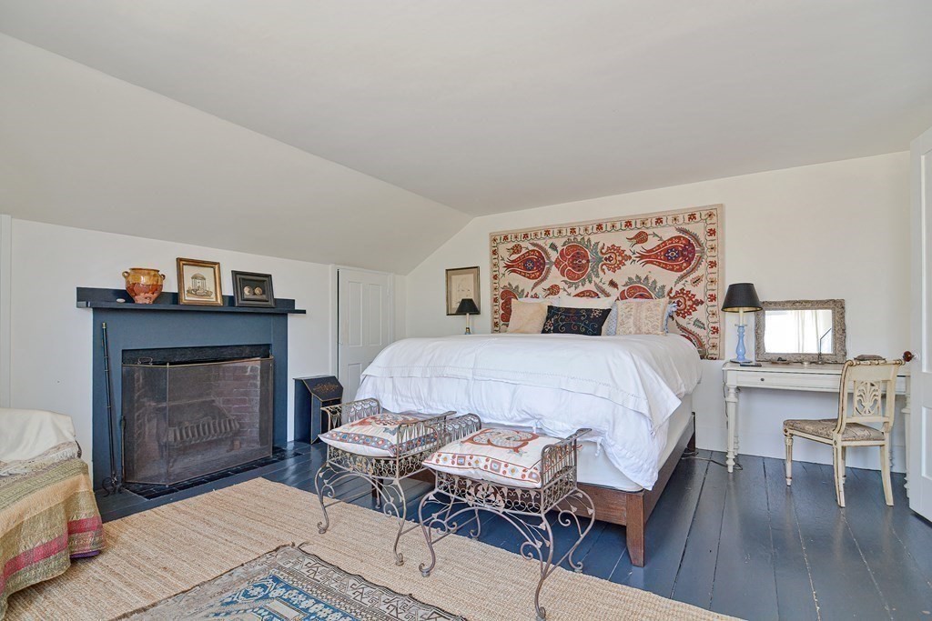 1904 Main Road Westport, MA 02791 - Photo 24 of 42 a bedroom with a bed and a fireplace
