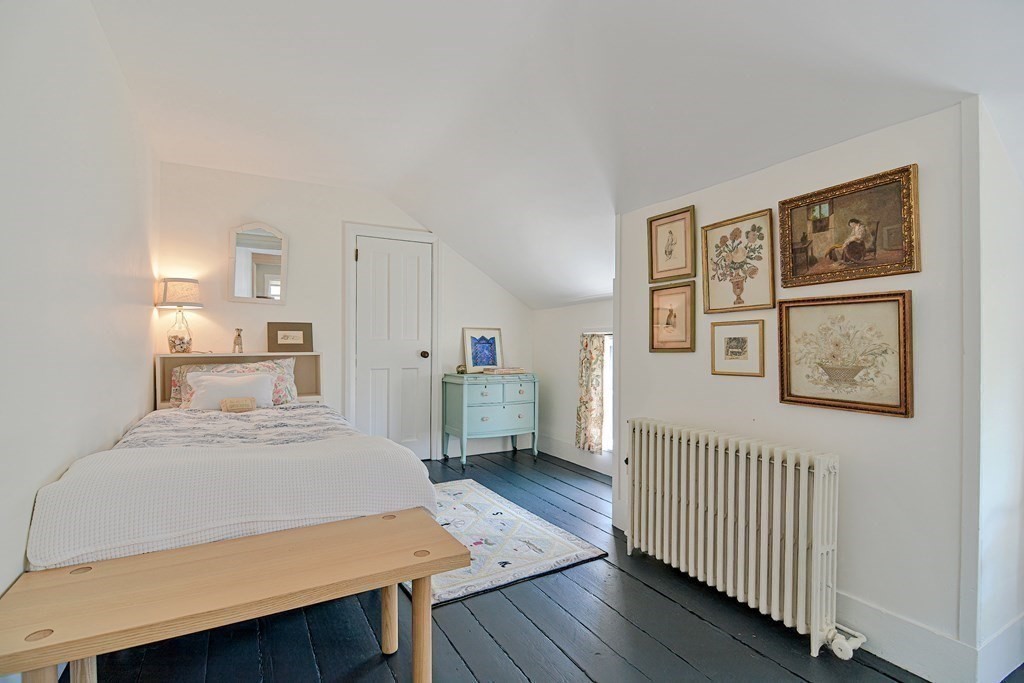 1904 Main Road Westport, MA 02791 - Photo 26 of 42 a bedroom with a bed and a table in it