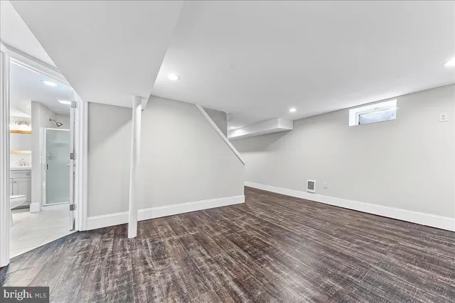 a bathroom with a granite countertop sink mirror and shower