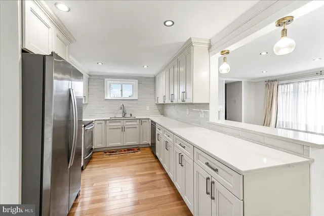 a large white kitchen with a large window
