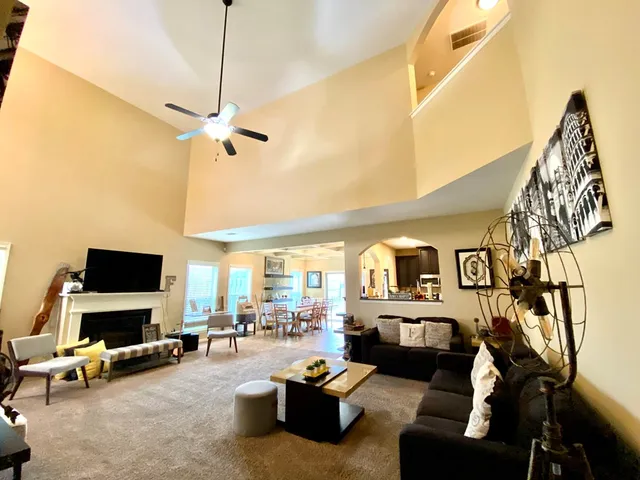 a living room with furniture gym equipment and a flat screen tv
