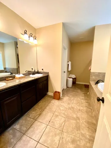 a bathroom with a sink mirror and a toilet