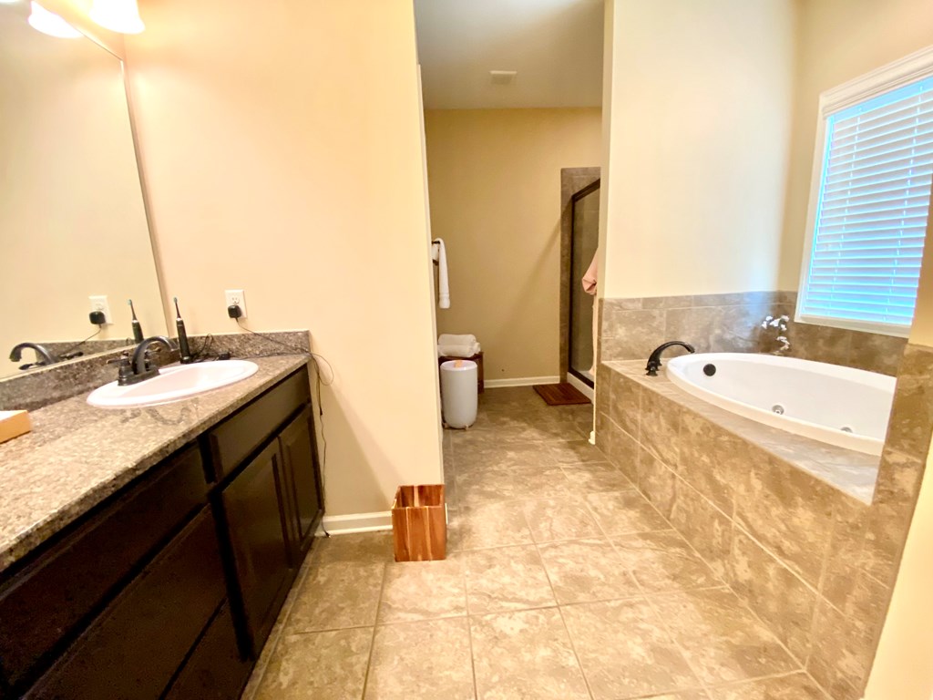 6065 Granite Field Drive Fortson, GA 31808 - Photo 22 of 39 a spacious bathroom with a tub sink and mirror