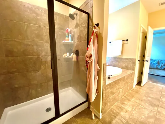 a bathroom with a tub and shower