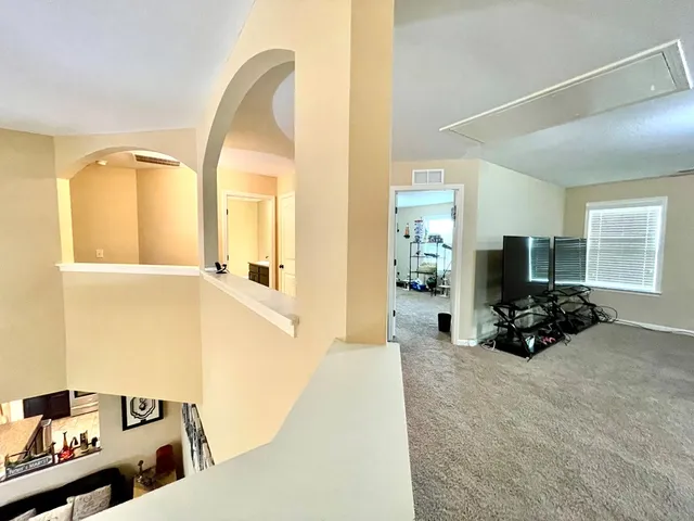 a view of a livingroom with furniture and a flat screen tv