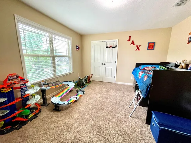 a view of play room with toys and a flat screen tv