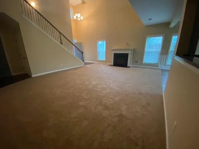 a view of a livingroom with an empty space and a fireplace