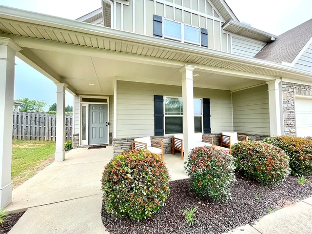 a view of a house with a chairs in patio