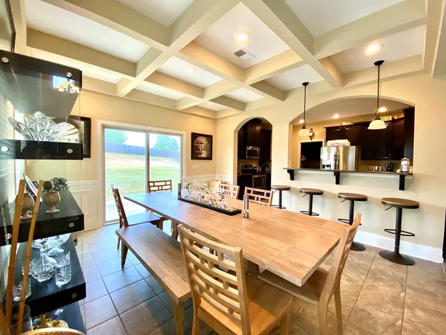a very nice looking dining room with a large window and chairs