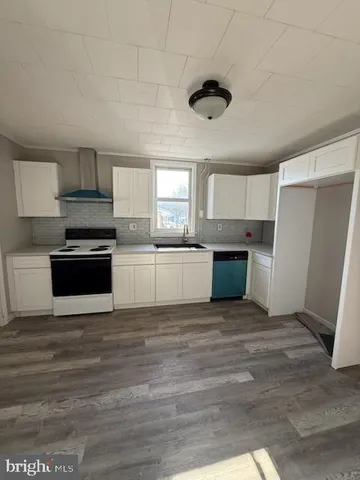 a kitchen with a refrigerator a sink and a stove