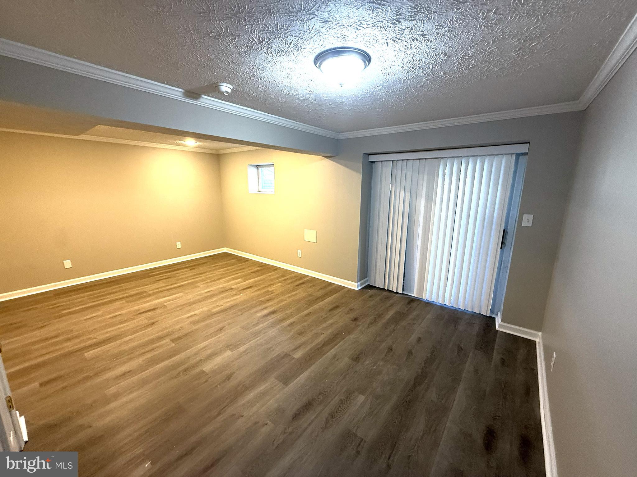 7604 Fox Hunt Court Clinton, MD 20735 - Photo 12 of 14 an empty room with wooden floor and windows