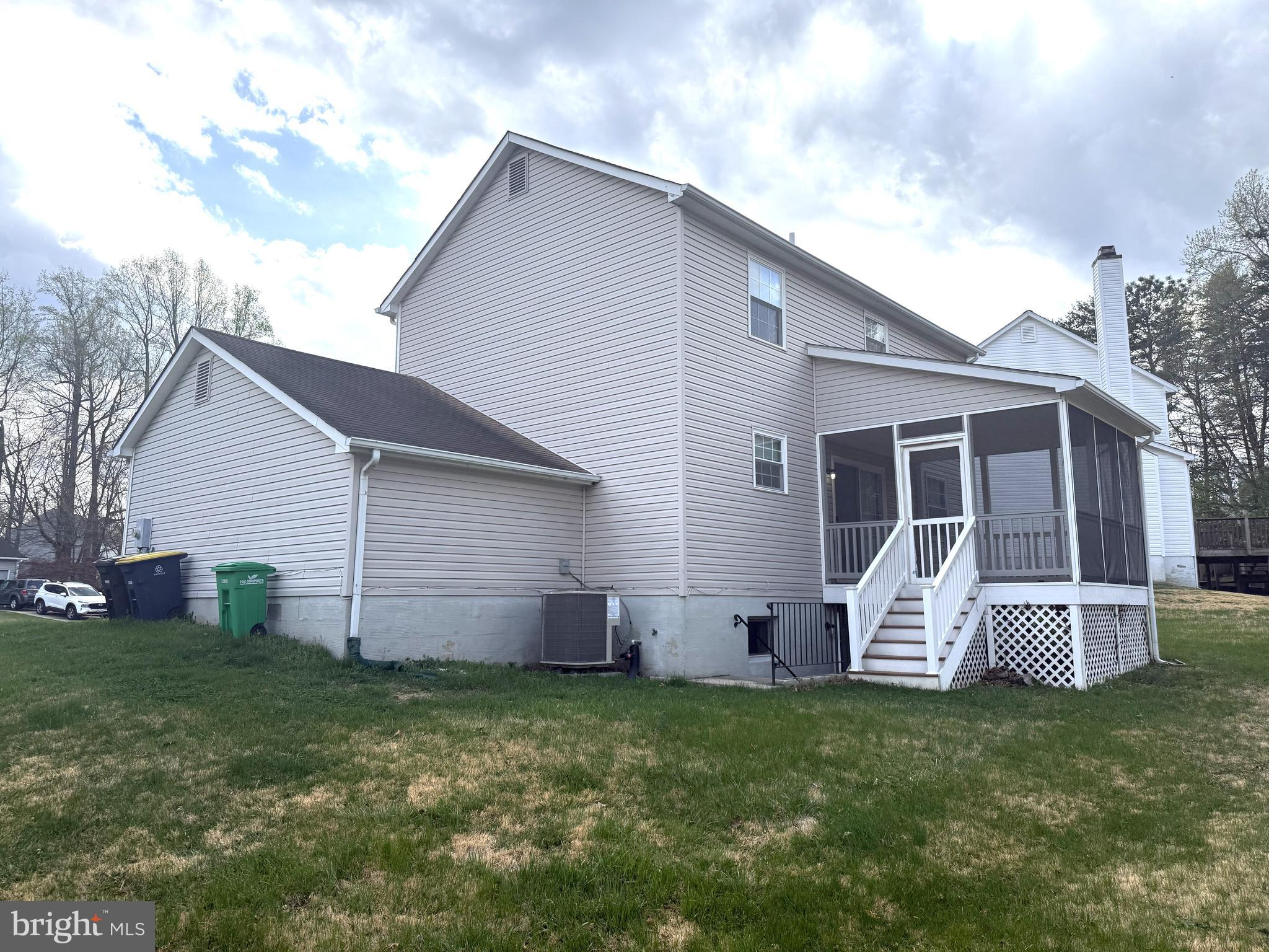 7604 Fox Hunt Court Clinton, MD 20735 - Photo 14 of 14 a backyard of a house with table and chairs plants and large tree