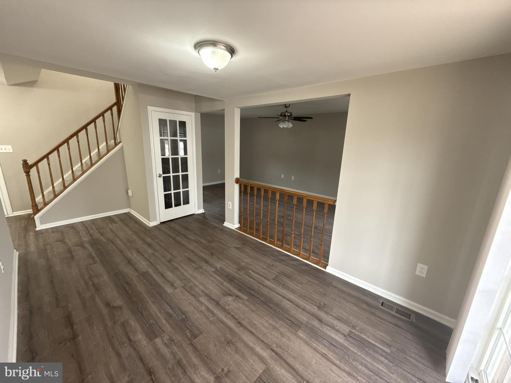 7604 Fox Hunt Court Clinton, MD 20735 - Photo 5 of 14 a view of an empty room with wooden floor and a window