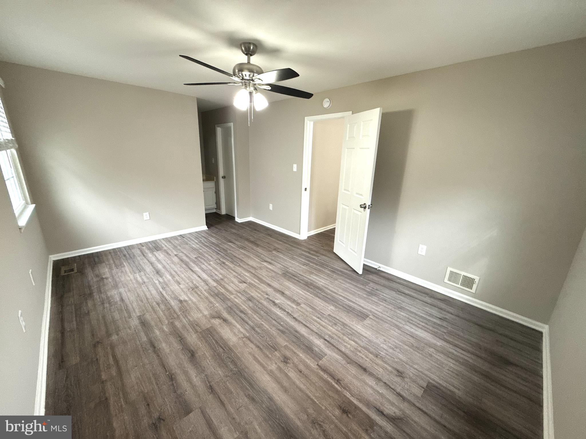 7604 Fox Hunt Court Clinton, MD 20735 - Photo 8 of 14 wooden floor in an empty room with a window