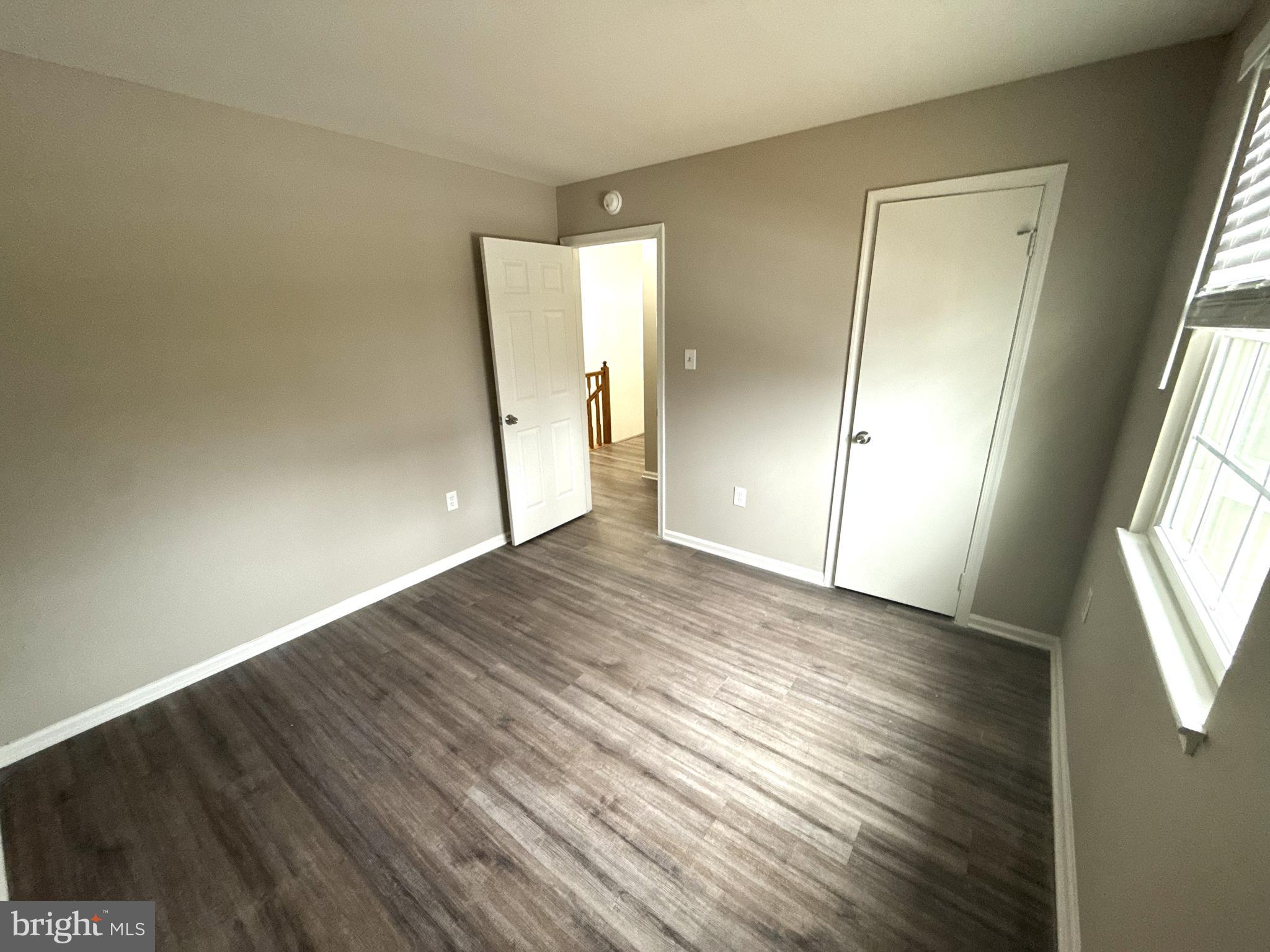 7604 Fox Hunt Court Clinton, MD 20735 - Photo 10 of 14 an empty room with wooden floor and windows