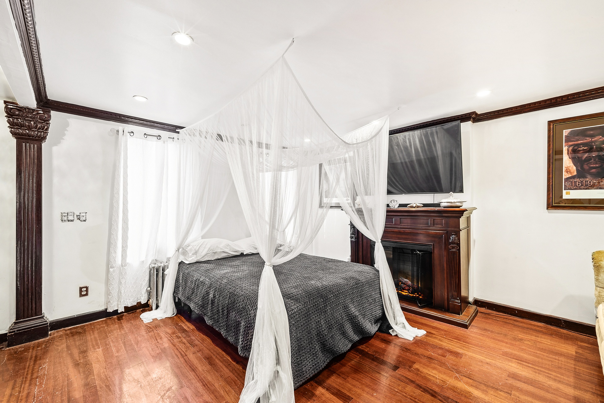 147 Patchen Avenue Brooklyn, NY 11221 - Photo 3 of 5 a bedroom with a bed and a fireplace