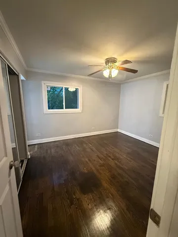 a view of a room with wooden floor and a window