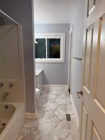 a bathroom with a bathtub and a shower