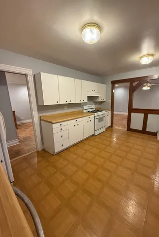 a large kitchen with stainless steel appliances granite countertop a stove a sink and a refrigerator