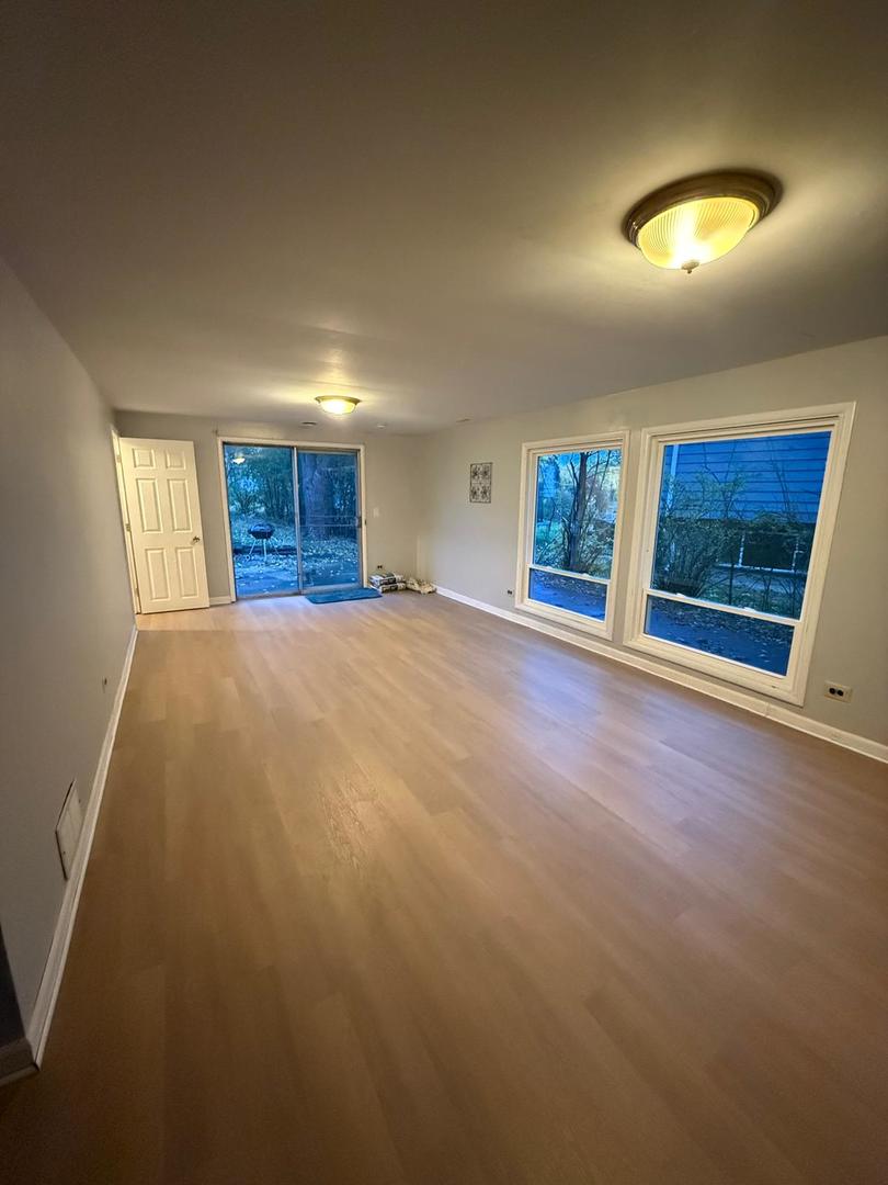 1440 Gentry Road Hoffman Estates, IL 60169 - Photo 10 of 15 an empty room with windows and fireplace