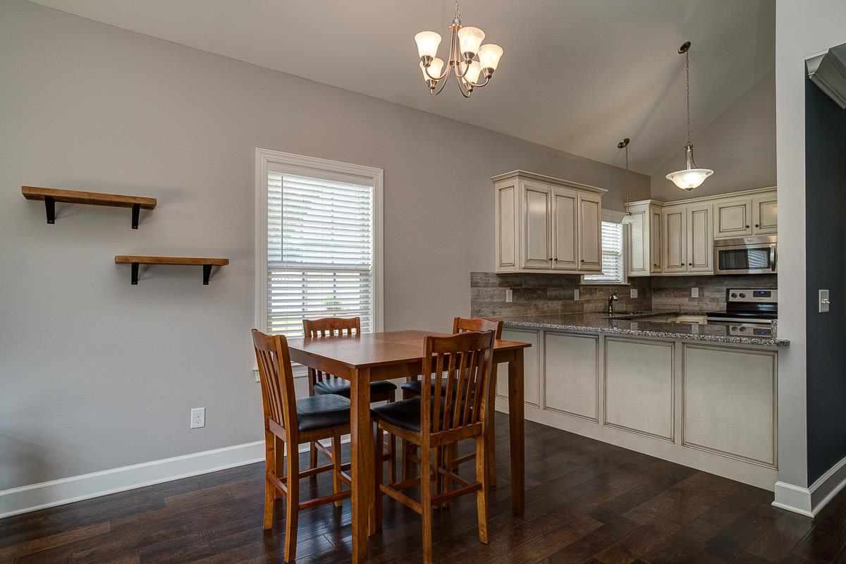 1021 Irish Way Spring Hill, TN 37174 - Photo 8 of 22 a view of a dining room with furniture and wooden floor
