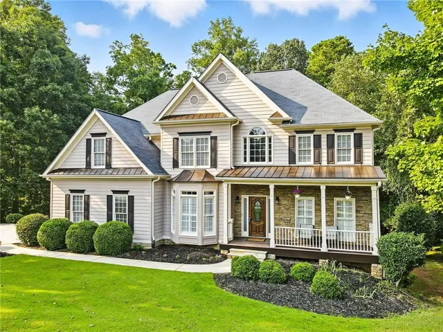 a front view of a house with a yard