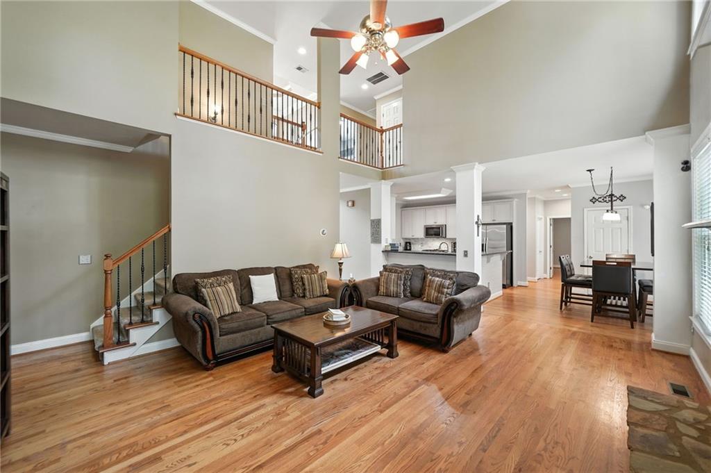 629 Gold Valley Pass Canton, GA 30114 - Photo 11 of 110 a living room with furniture a wooden floor and a chandelier