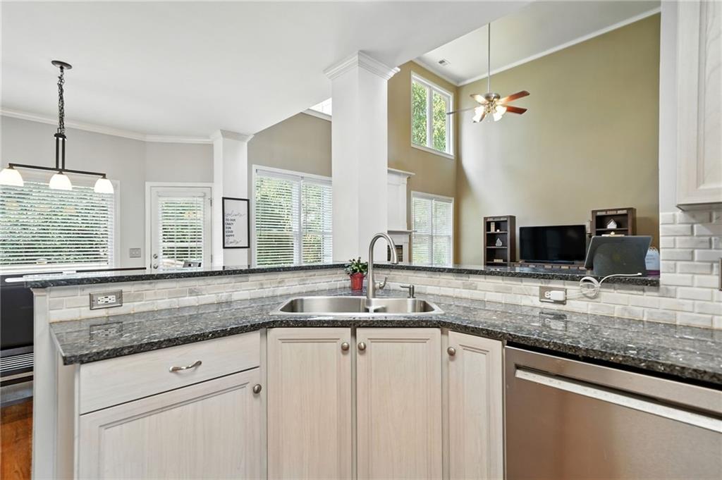 629 Gold Valley Pass Canton, GA 30114 - Photo 14 of 110 a kitchen with granite countertop a sink and a window