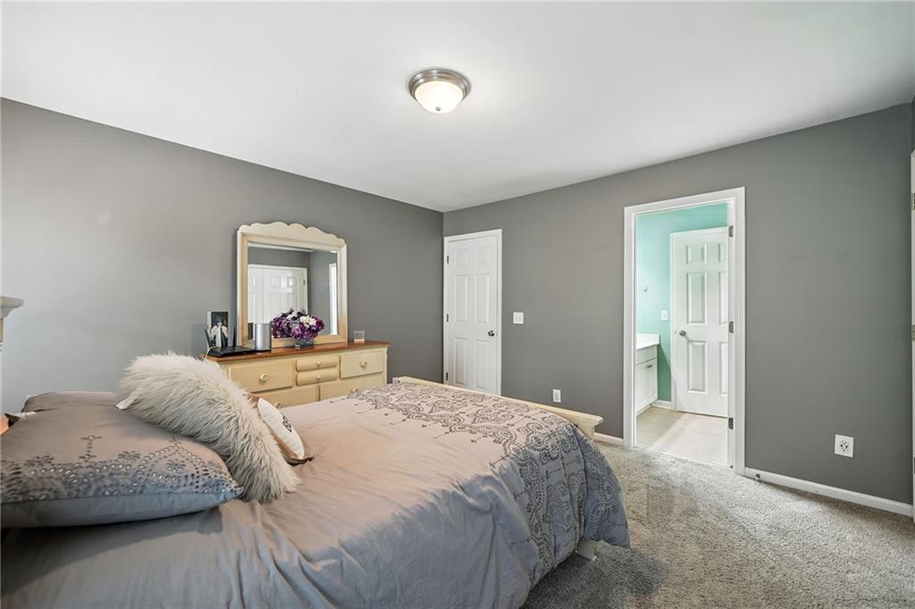 629 Gold Valley Pass Canton, GA 30114 - Photo 35 of 110 a bedroom with a bed and a mirror
