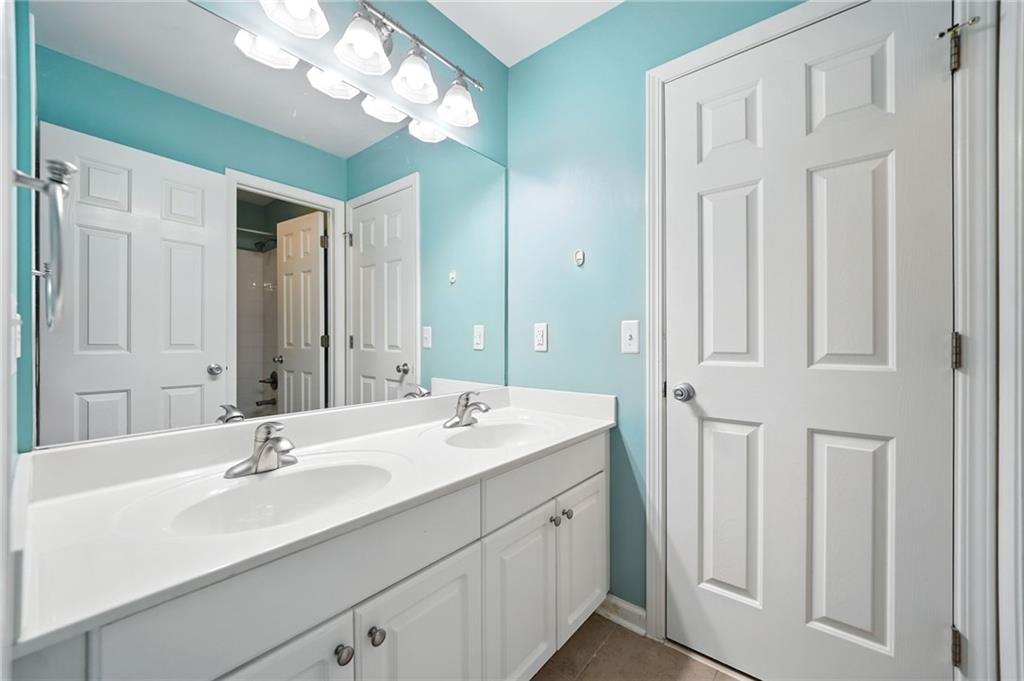 629 Gold Valley Pass Canton, GA 30114 - Photo 36 of 110 a bathroom with a double vanity sink and a mirror