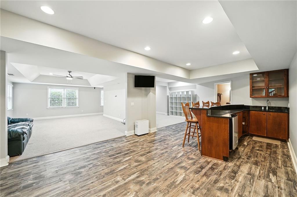 629 Gold Valley Pass Canton, GA 30114 - Photo 44 of 110 a living room with furniture and a flat screen tv
