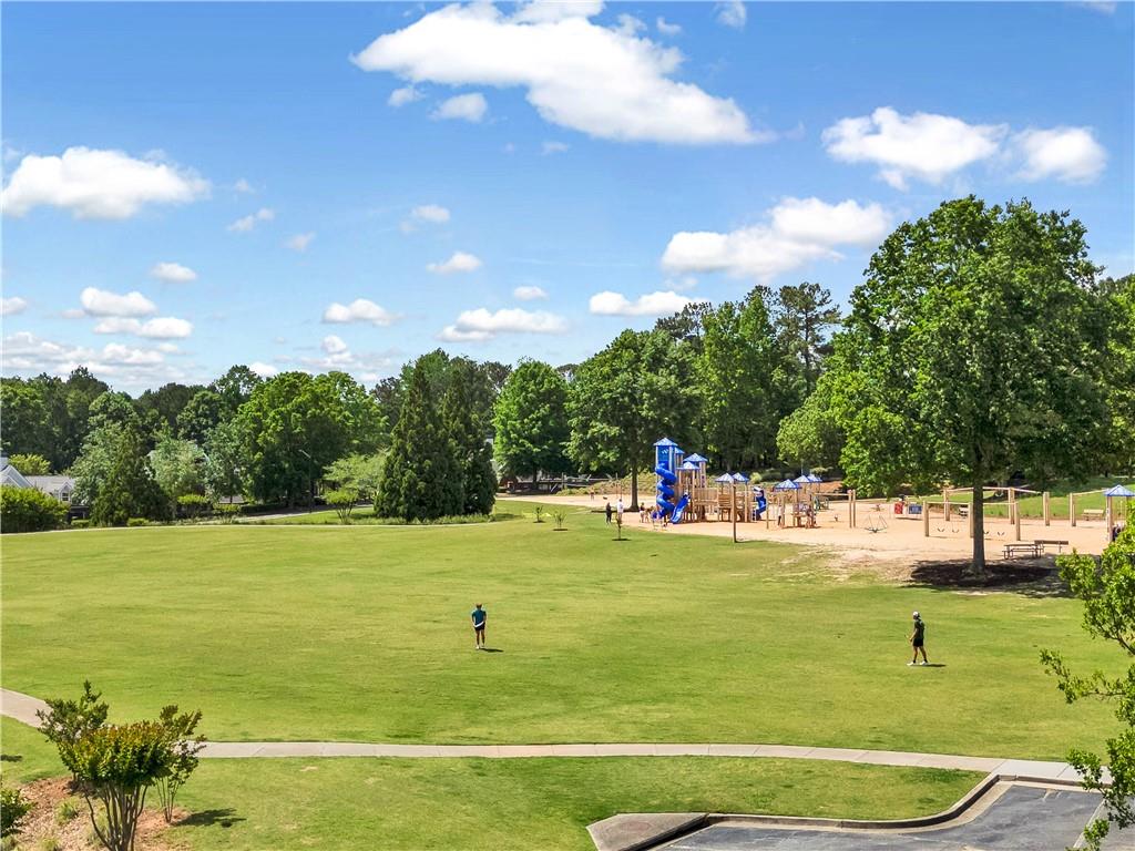 629 Gold Valley Pass Canton, GA 30114 - Photo 80 of 110 a view of a golf course with a lake