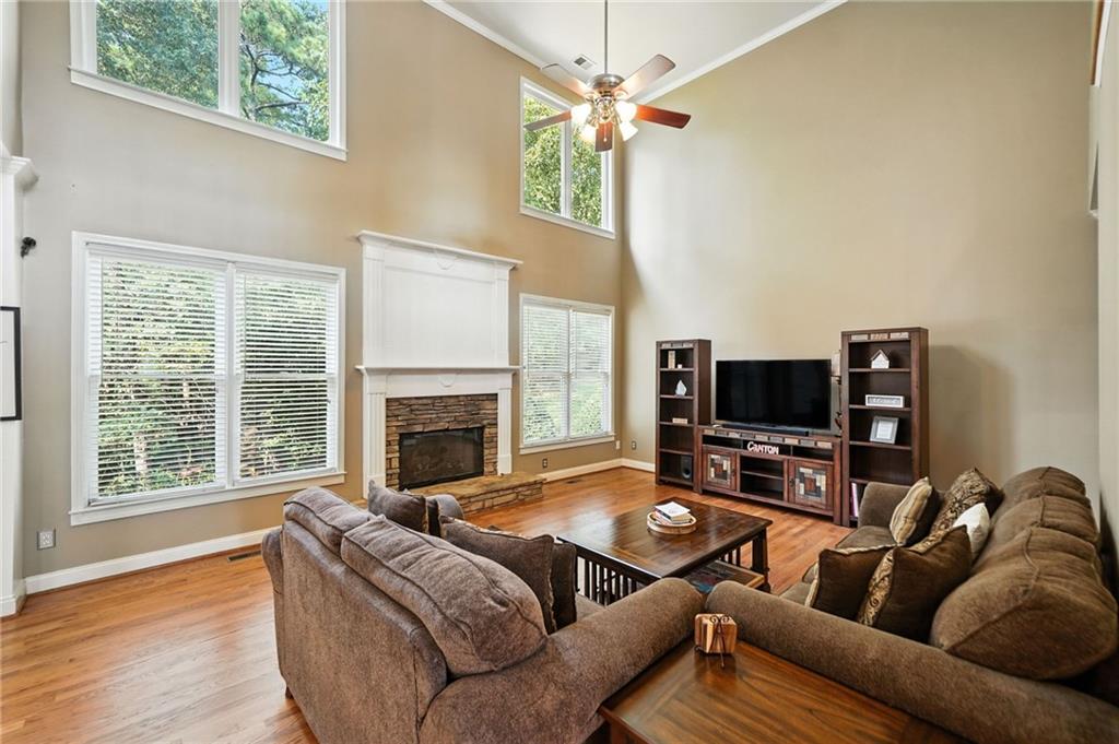 629 Gold Valley Pass Canton, GA 30114 - Photo 8 of 110 a living room with furniture a fireplace and a flat screen tv