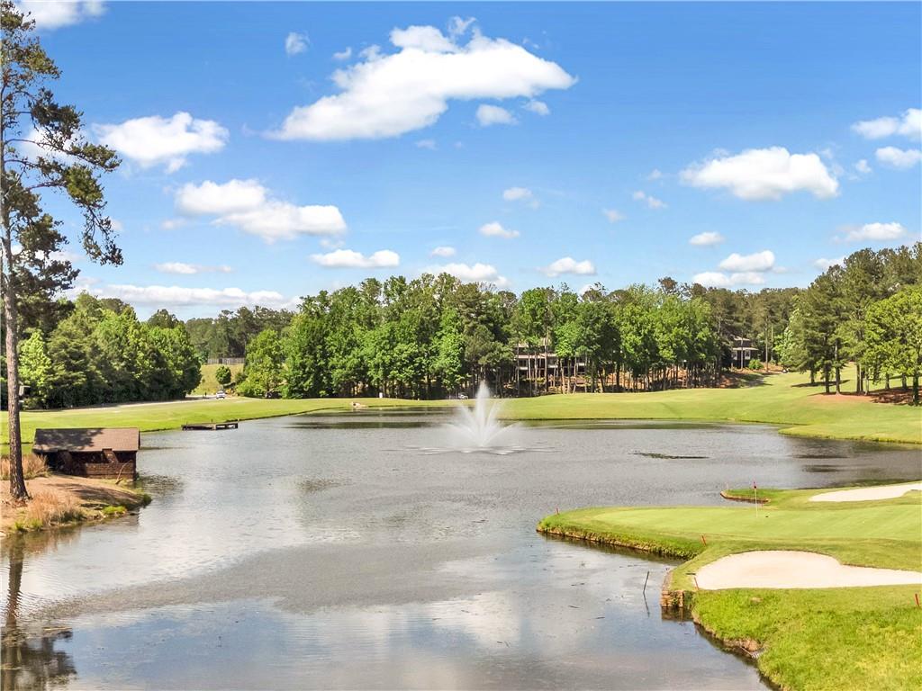 629 Gold Valley Pass Canton, GA 30114 - Photo 85 of 110 a view of a swimming pool and trees in the background