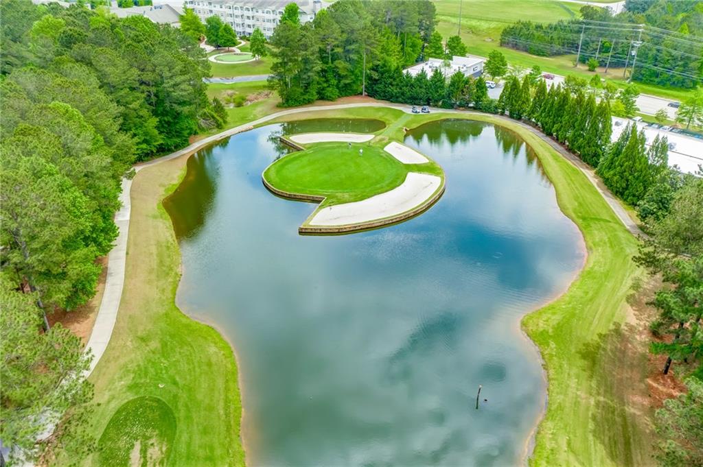 629 Gold Valley Pass Canton, GA 30114 - Photo 89 of 110 a view of a swimming pool with a yard and large trees