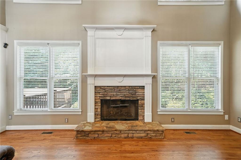 629 Gold Valley Pass Canton, GA 30114 - Photo 9 of 110 a living room with a fireplace and wooden floor