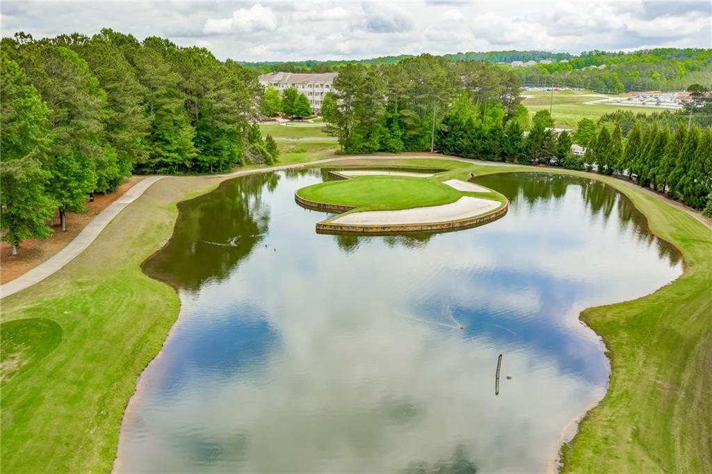 629 Gold Valley Pass Canton, GA 30114 - Photo 92 of 110 a view of a swimming pool with a yard and large trees