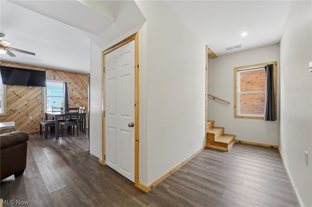 5919 Lake Road West, Unit 32 Ashtabula, OH 44004 - Photo 13 of 23 Hallway with wood walls and dark wood-style flooring